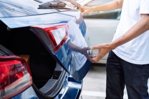 Man open hatchback car for trunk